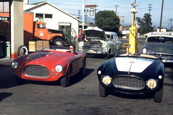 In 1953, Phil Hill and Bill Spear drove their Ferraris from Los Angeles to Pebble Beach and finished first and second in the race. The car on the right is Spears 340 Mexico Vignale Spyder. It was on the old course tour, brought by Les Wexner. It is now painted red but Wexner has heard many voices calling for it to be returned to its original American racing colors of blue and white. Sitting in Phil’s 250 MM Vignale Spyder is Phil’s date for the weekend who would later marry Ernie McAfee. Credit: Phil Hill.